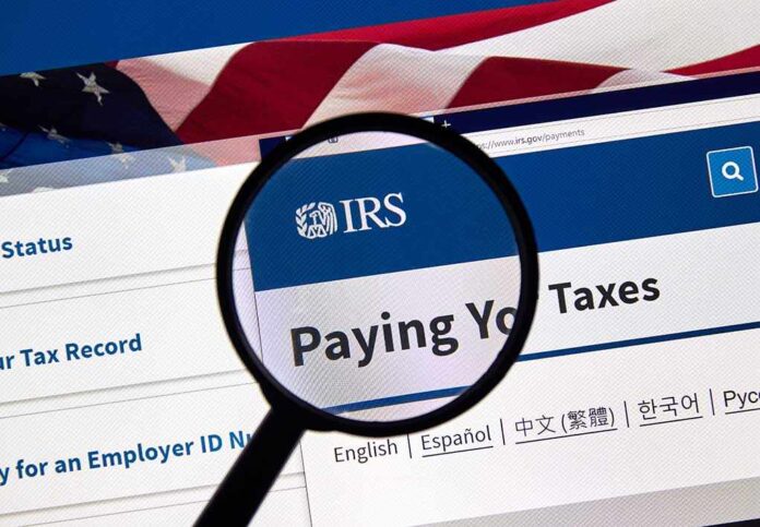 1383312209 featured image Magnifying glass over IRS website for paying taxes
