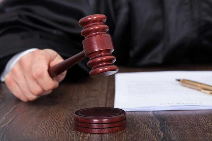 186812807 featured image Judge's hand holding gavel over documents