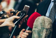 Close-up of various microphones held towards a person