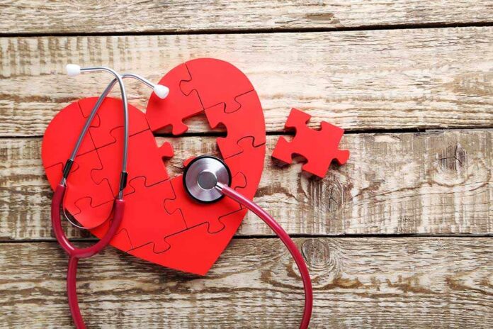 538329796 featured image Red heart puzzle with stethoscope on wooden background.