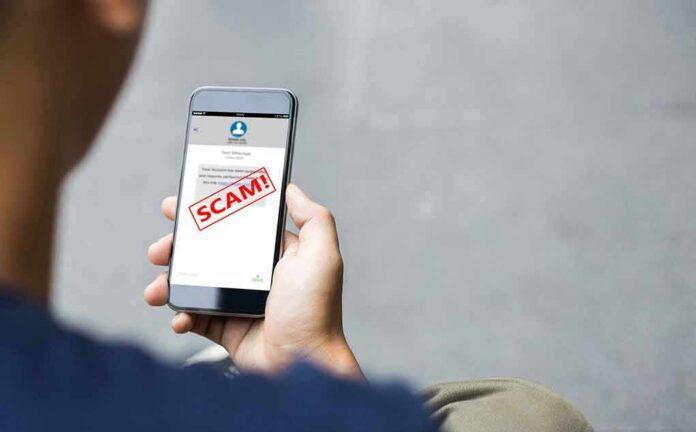 2058303887 featured image Person holding phone with scam alert message