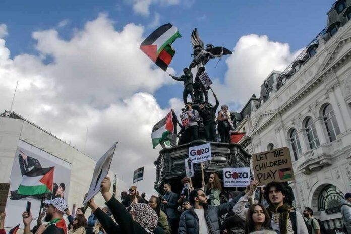 2375391109 featured image Protesters with flags and signs near a statue