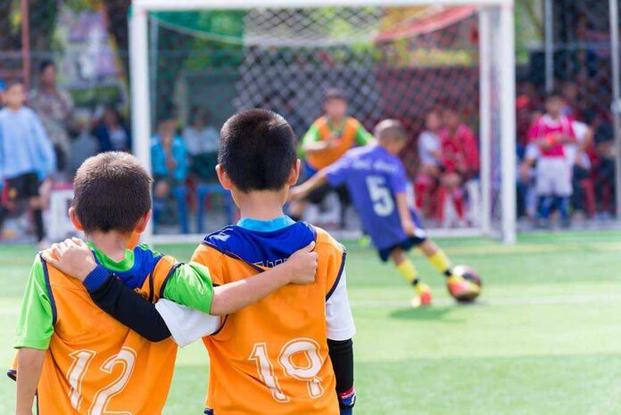 366972005 featured image Two boys watching a soccer game together