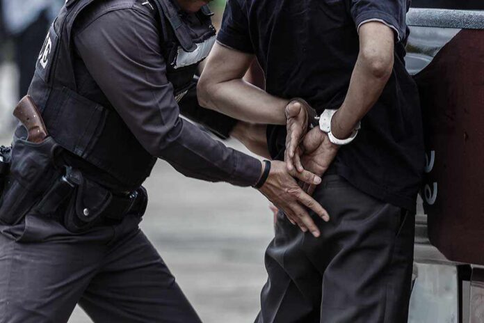 665013085 featured image Police officer arresting a person with handcuffs