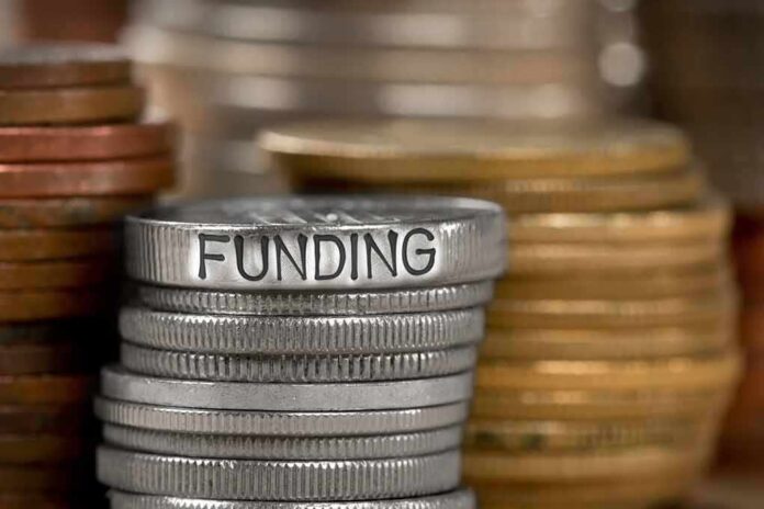 784896787 featured image Stack of coins labeled funding with other coins stacks