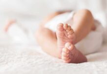 Close up of baby feet lying on blanket