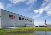 SpaceX building with American flag and launch pad