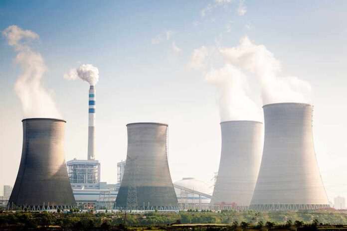 164603351 featured image Four cooling towers of a power plant emitting steam