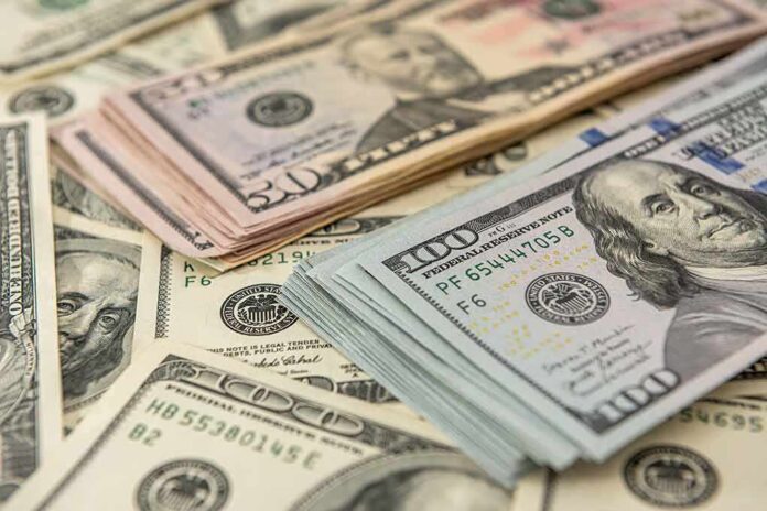 Stacks of various U.S. dollar bills