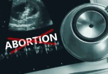 Ultrasound stethoscope and ABORTION crossed out in red