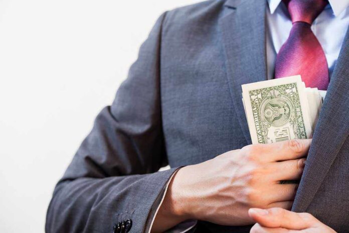 394112617 featured image Person in suit putting money in jacket pocket