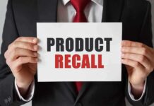 Product Recall sign held by person in suit
