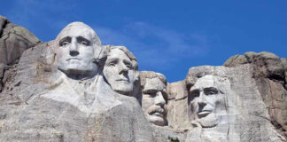Mount Rushmore with four presidential faces carved in rock