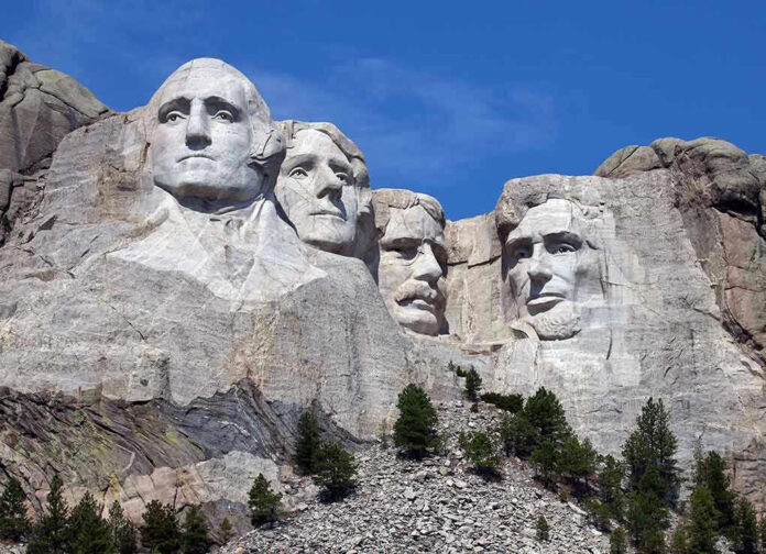 Mount Rushmore with four presidential faces carved in rock
