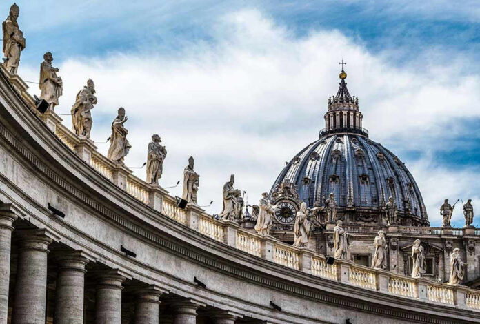 St. Peter's Basilica dome with statues and clouds