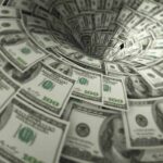 Hundred-dollar bills swirling into a financial vortex