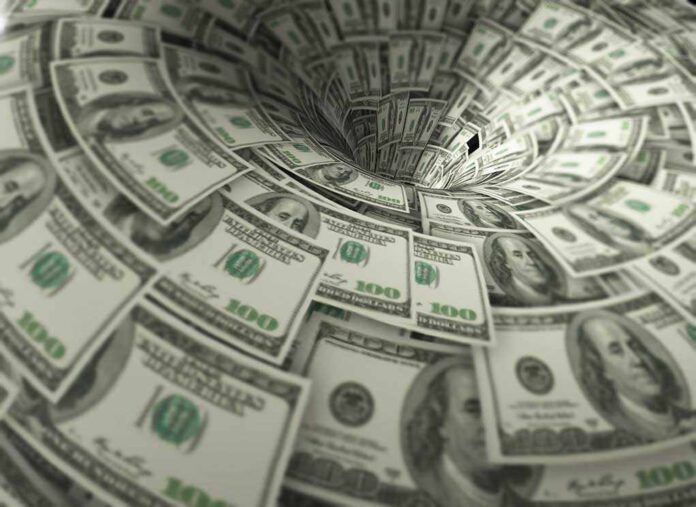 760572118 featured image Hundred-dollar bills swirling into a financial vortex