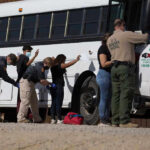 Mexico SURRENDERS 26 Cartel Kingpins Border patrol officers investigating people near a bus.