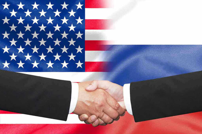 Hands shaking in front of USA and Russia flags