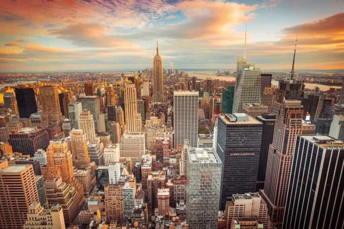 Aerial view of New York City skyline during sunset with skyscrapers and clouds