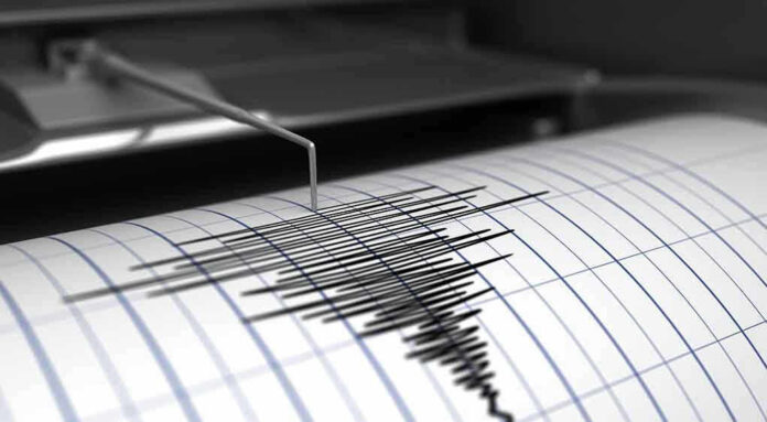 Seismograph needle recording earthquake activity on paper.