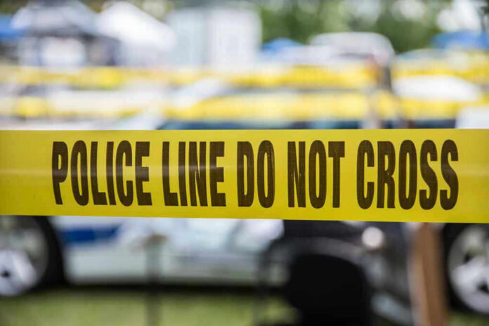 Yellow police line tape with Do Not Cross.