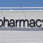 Sign displaying the word pharmacy against a white background