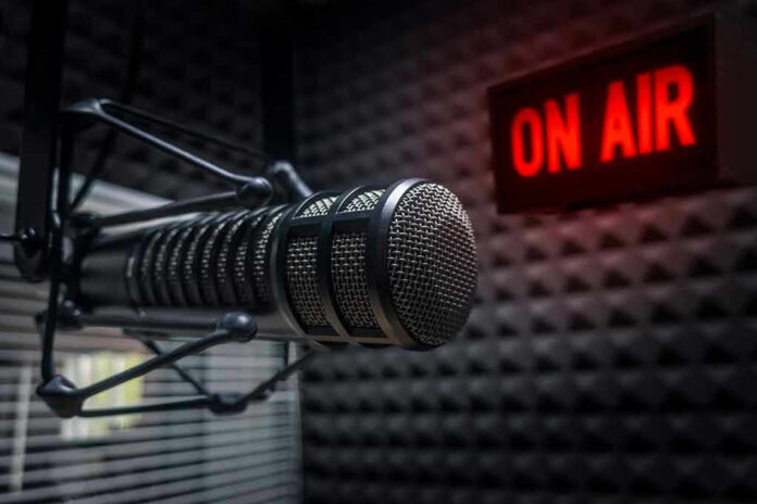 121852805 Microphone in soundproof studio with On Air sign.