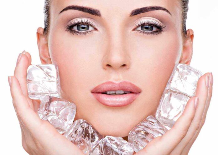 shutterstock_163387733.jpg Close-up of a woman holding ice cubes around her face