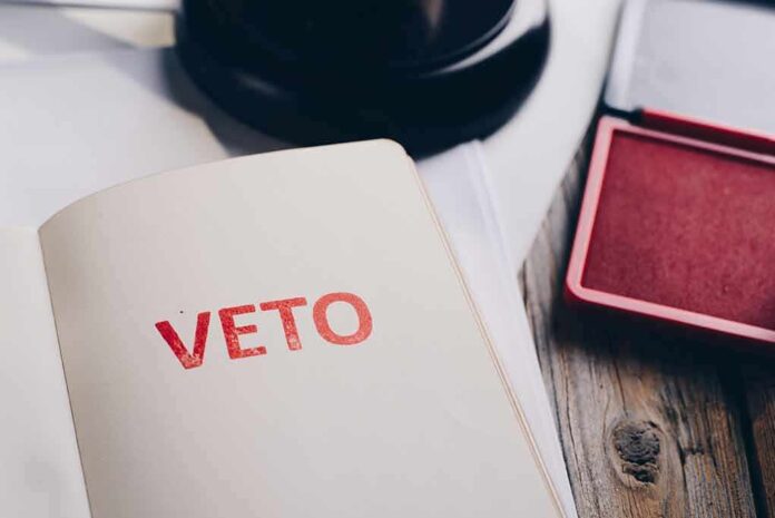 A stamped document with the word 'VETO' in red ink