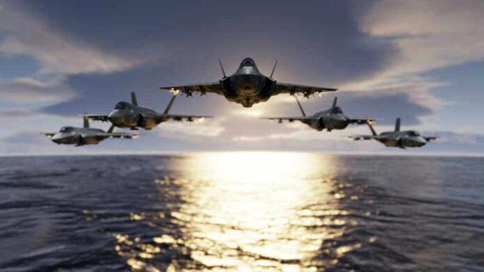 Five fighter jets flying over the ocean at sunset.