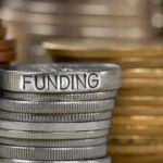 Stack of coins labeled funding with other coins stacks