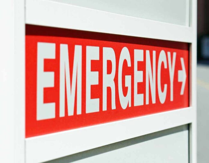 Emergency sign indicating direction with a red background and white text