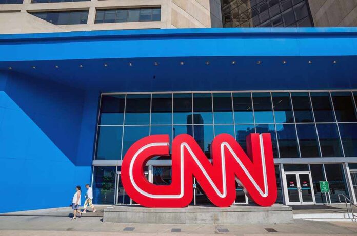 Exterior view of the CNN building with a large red logo and blue facade