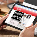 Zelensky’s KEY Party Members ARRESTED Person reading news headline Scandal Unfolds on tablet