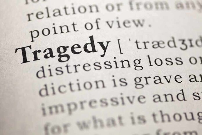 Close-up of a dictionary page showing the definition of 'tragedy'