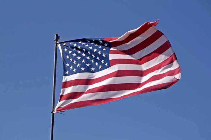 Waving American flag against a clear blue sky