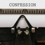 Typewriter with CONFESSION on paper.
