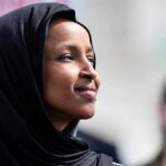 Ilhan Omar’s Husband INVESTIGATE: $30M Mystery EXPLODES! Woman wearing a black hijab looking thoughtfully into the distance
