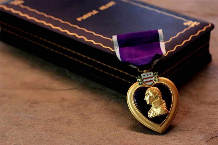 Purple Heart medal with a portrait of George Washington next to a vintage book