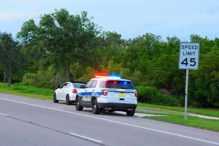 Police car pulling over a white car