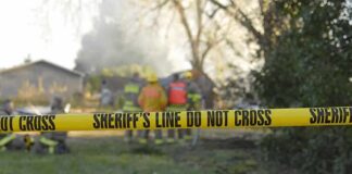 Mistrial Shocker: 1986 Girl’s Killer May Walk Free Yellow police tape marking a restricted area at a fire scene with firefighters in the background