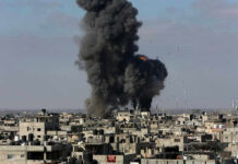 Large explosion over a crowded urban area.