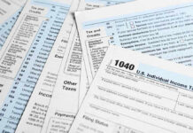 Tax forms and documents overlapping on surface