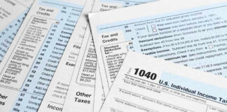 Tax forms and documents overlapping on surface