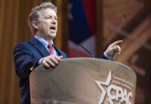 Historian Calls GOP “Nazi Propagandists” A politician delivering a speech at a conference podium