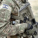 Netanyahu Dares Trump Deal Soldier in camouflage gear with Israeli flag patch.