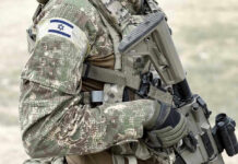 Netanyahu Dares Trump Deal Soldier in camouflage gear with Israeli flag patch.