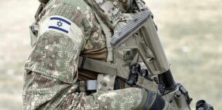 Netanyahu Dares Trump Deal Soldier in camouflage gear with Israeli flag patch.