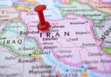 Iran Spin War Exposed — Deal Hype Crumbles Red pushpin marking Iran on a map.